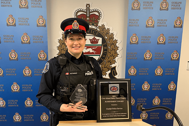 A member of the Guelph Police Service poses with their 2021 CAA Program Achievement (Police) Award.