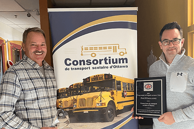 Two members of the Consortium de transport scolaire d’Ottawa pose with their 2021 Program Achievement (Community) Award.