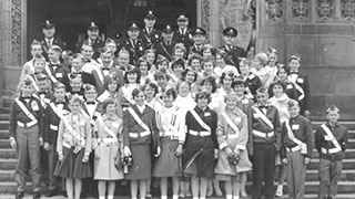 Black and white photo of a large group of Guelph-area School Safety Patrollers and Guelph police officers, posing in front of Parliament Hill, 1969. 
